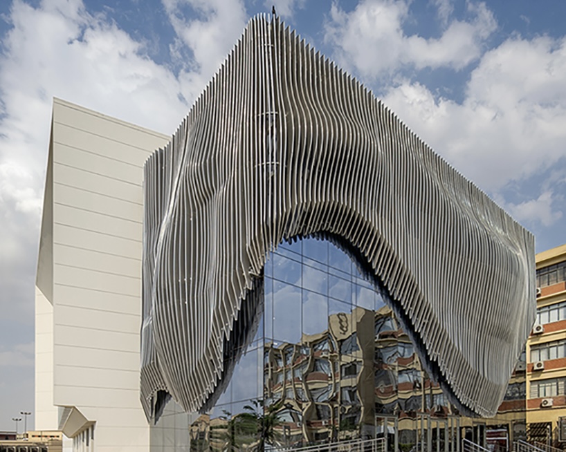 Undulating Aluminum Curtain Facade Drapes Over Ain Shams University Theater in Egypt