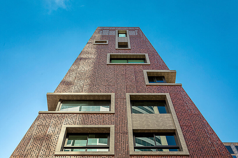 perforated red aluminum skin envelops gisele borges