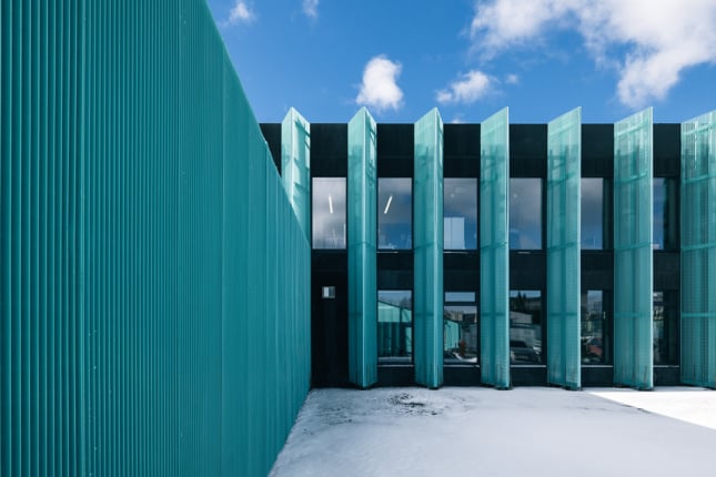 An Estonian office block receives a splash of color with an aluminum mesh facade